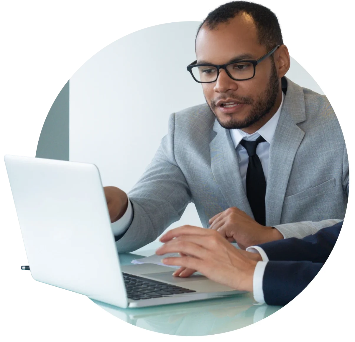 Photo of a man working with team on laptop.